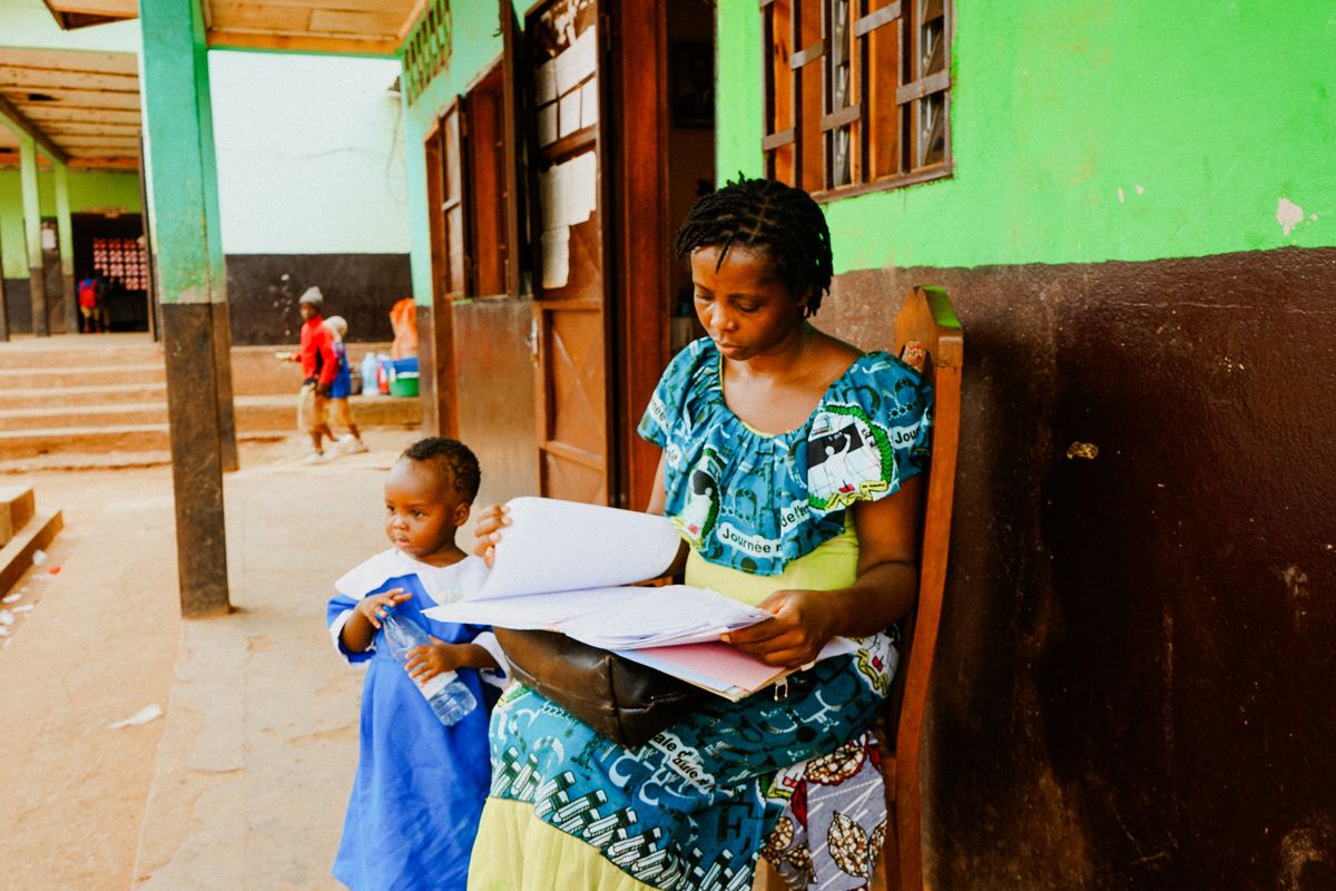 Mother Reading With Child at School Entrance