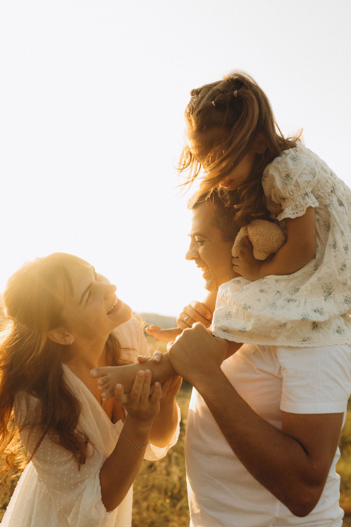 Happy Family Playing Outdoors in Sunshine