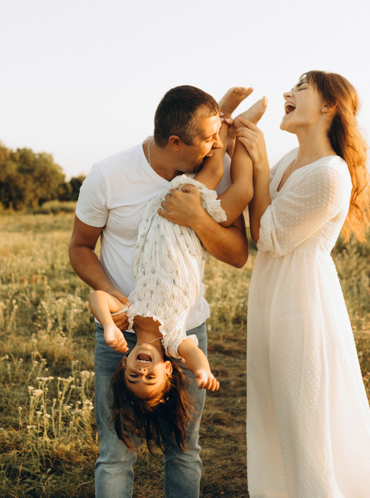 Happy Family Playing Outdoors in Summer