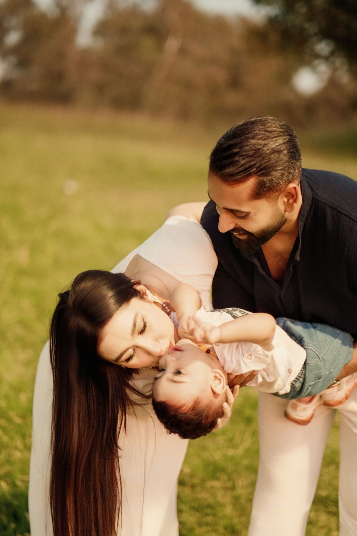 Happy Family Playing Outdoors in the Sun